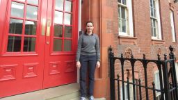 Joanna Jones outside the red doors of ACSE's Amy Johnson Building