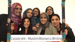 A group of women holding a 'celebrate - Muslim women's writing' on
