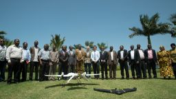 People stood in a line around a drone