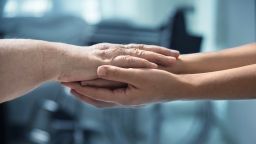 Photo of a young and older person's arms stretched out to lay the older person's arms across the younger arms.