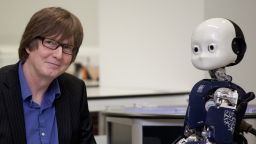 Tony Prescott shaking hands with the iCub robot