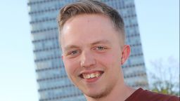 Headshot of Declan Maurice stood in front of the Arts Tower smiling