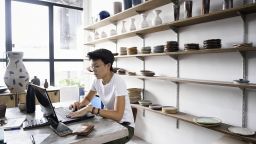 Small business owner using computer inside store