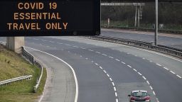 An empty motorway with a Covid-19 sign