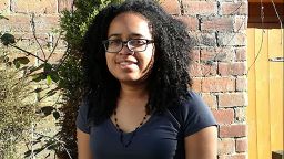 Student Hailey Pottinger stood in front of a brick wall smiling