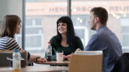 Three students having a conversation in Jessop West Cafe 