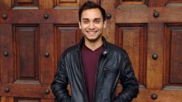 Photograph of Abhishek standing by a door.