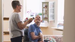 A carer supporting a person using a wheelchair