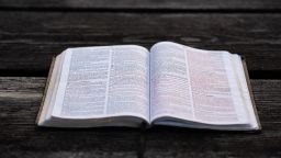 A book open on a wooden table