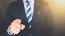 A man in a suit pointing a finger