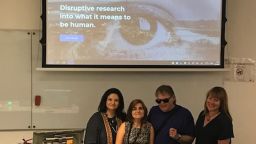A group of people stood in front of a presentation