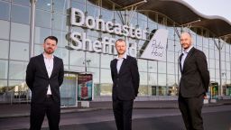 Three representatives from the University of Sheffield, DSA and Peel L&P stood in front of DSA's terminal building