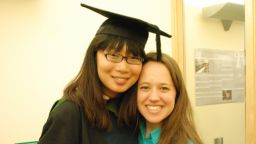 two people smiling at camera at graduation with hat and rope