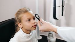 A child having their eyes examined