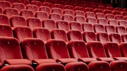 Rows of empty red seats in a cinema