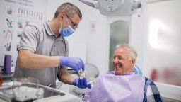 Dentist showing patient dentures