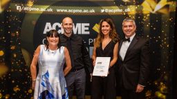 Four members of print and design solutions team receiving an award