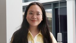 Xinyi Huang wearing a yellow and white shirt.