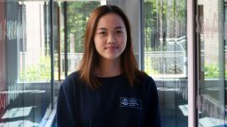 Velicia B. Hartono wearing a navy blue sweatshirt displaying the Management School's logo.