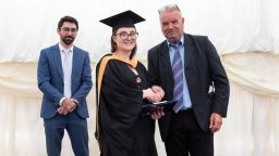 Chloe Tolley receiving a prize at graduation with Dr Adam Hodgson and Len Garnham.