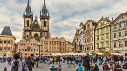 Tourists soaking up the atmosphere in the Old Town Square of Prague