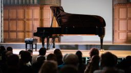Piano on stage with audience 