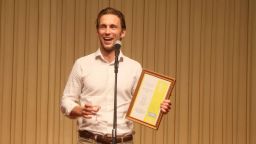 Christiaan Roell receiving an award at EAMSA 2022.