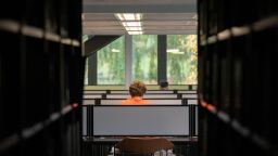 A person sitting at a desk in Western Bank Library. 