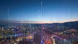 An image of a city scape with an abstract graphic representation of mobile networks