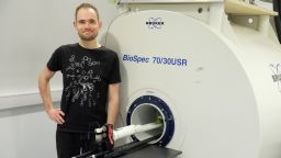 Richard Hodgkinson standing in front of a scanner