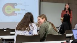 Two teenagers working in a classroom