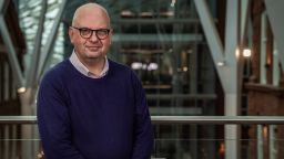 Professor Peter Styring stood on a balcony inside the University's Heartspace building