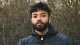 Gaailashwaran stood outside in front of some trees with a warm coat on
