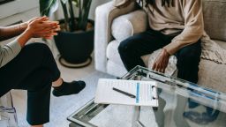 Image of two people sitting on sofas in therapy setting