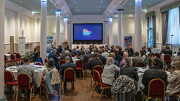 Image of the Productivity Puzzle event, image shows a conference room with a speaker stood at the podium