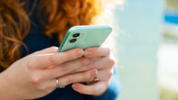 A close up of a woman holding a mobile phone