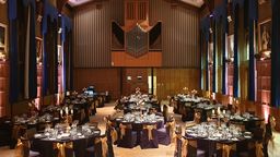 Firth Hall filled with circular tables nicely decorated for a large dinner
