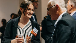 Sheffield alumnus and student engaged in conversation.