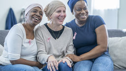 Group of women wearing breast cancer awareness badges