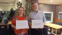 Damian Hodgson and Cate Goodlad holding certificates.