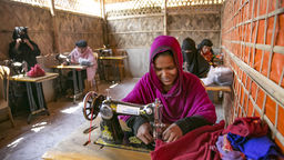 A scene at the Women's Center in Balukhali camp - Rohingya refugee at a sewing machine repairing clothes