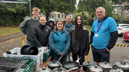 A group of students and staff ready to give out kitchenware at the Free Shop