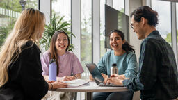 Four young people sitting at a coffee table
