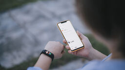 person using smart watch and phone