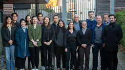 Group of people stand outside the digital humanities institute for a group photo