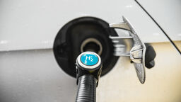 A close up of a fuel pump connected to a car