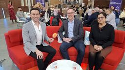 Three people sat on a sofa, including BBC news host Ben Boulos alongside Gurleen Popli and Jesse Matheson 